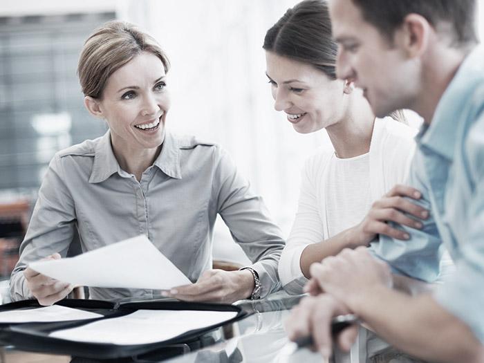 Business people looking at papers | Atradius